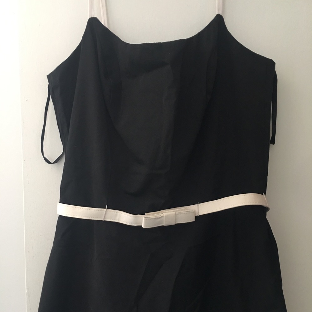 Black dress with ruffles and white bows